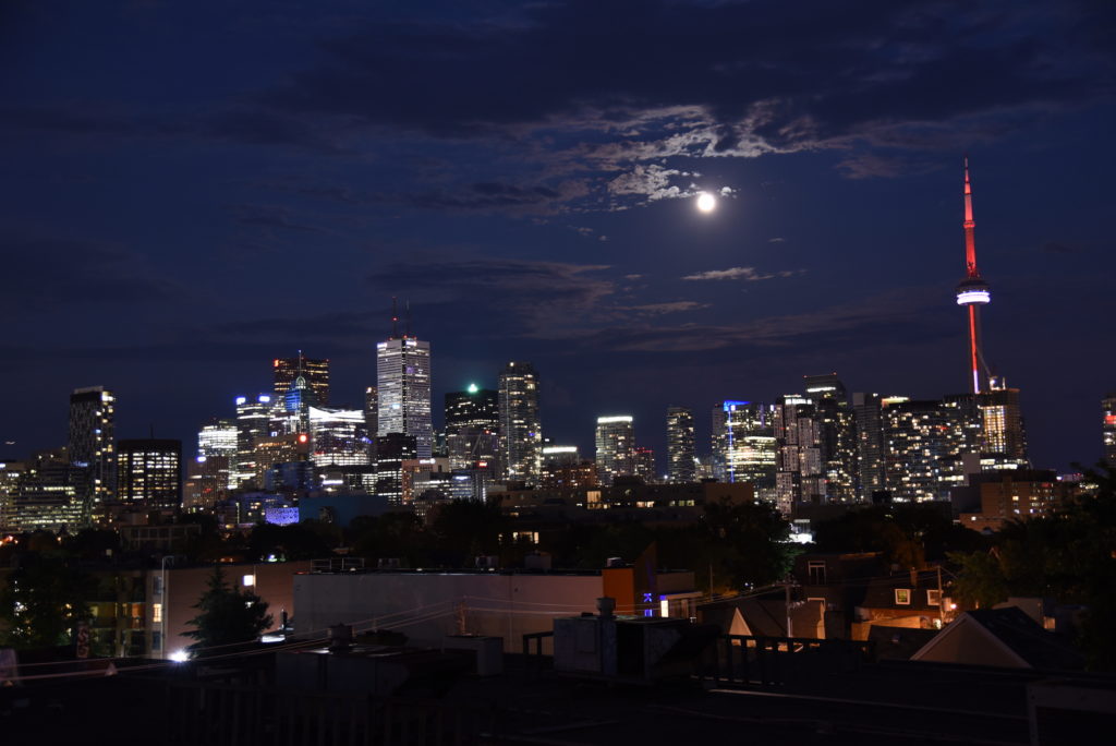 Toronto skyline by night with full moon