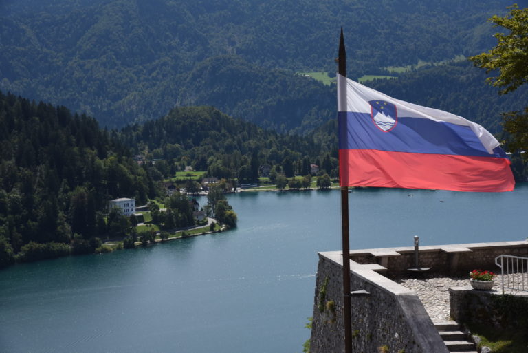 Slovenian flag with lake in the background